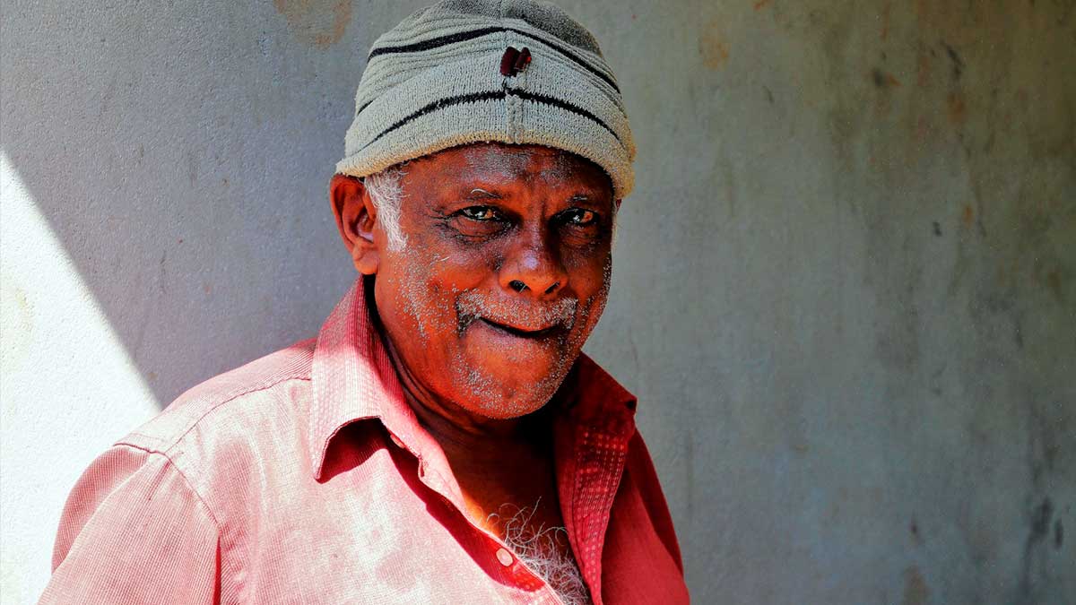 Capture of an elderly gentleman standing partially in sunlight with his face in shadow