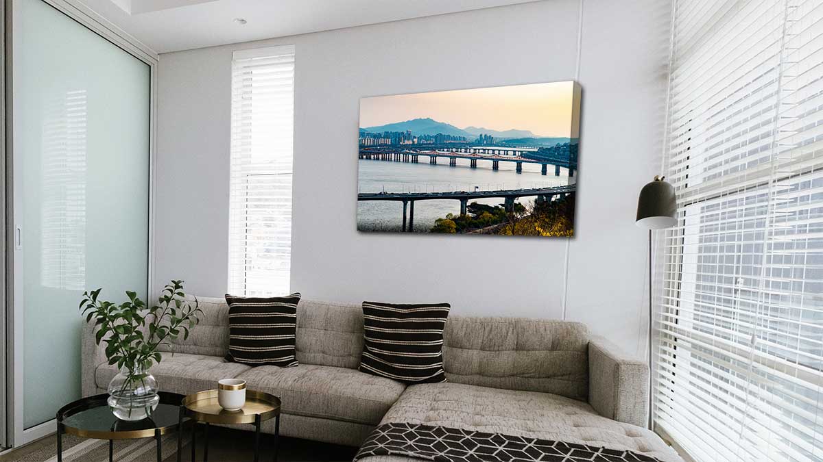 A family sitting room with a canvas print of a landscape holiday picture hanging on the wall.