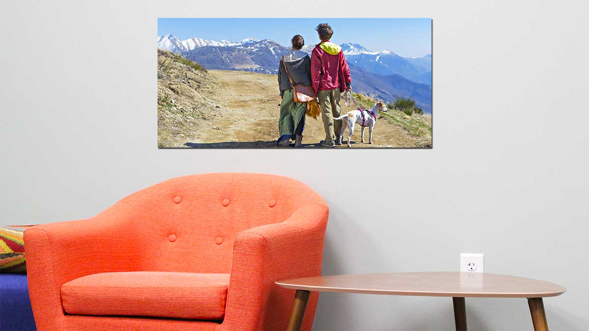 Panoramic photo print of a couple waking their dog within a picturesque mountain range