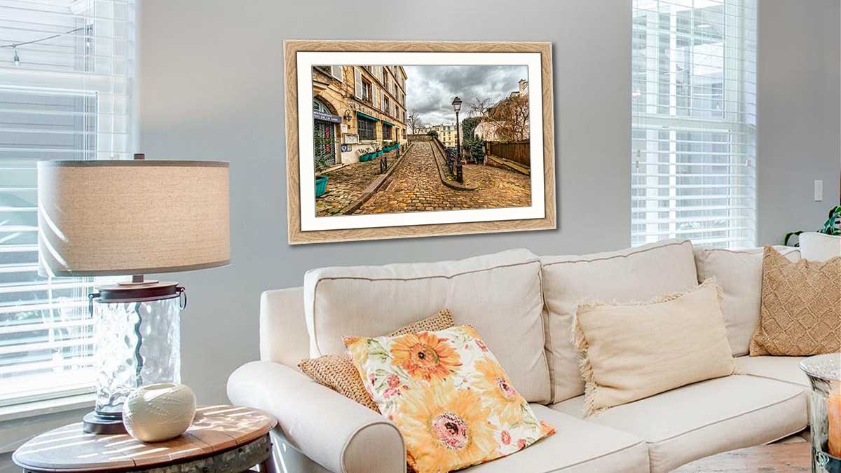 Photo taken on a city break, framed in our walnut stained frame with gold sight edge. Hung in a very traditional sitting room with a cream sofa and fluffy cushions